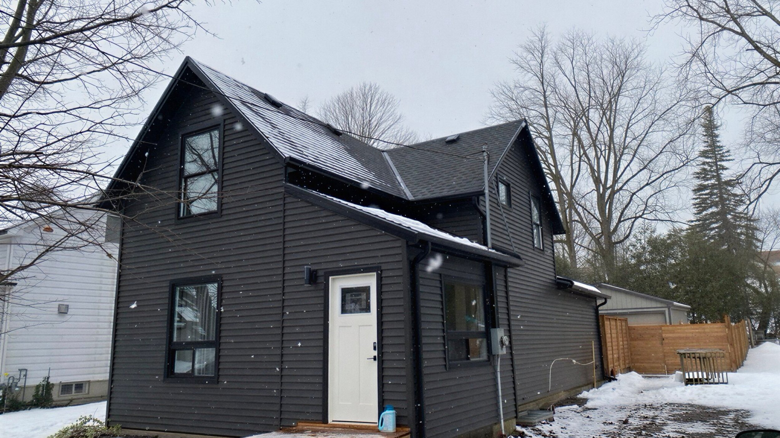 Port Elgin Home with vinyl siding and new gutters under snow